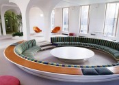 a round conversation pit with built-in green sofas, a round table in the center is a lovely idea for a mid-century modern space