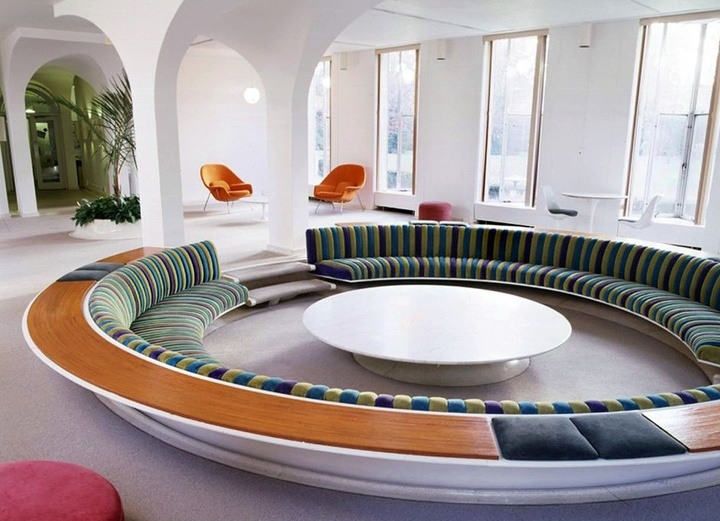 A round conversation pit with built in green sofas, a round table in the center is a lovely idea for a mid century modern space