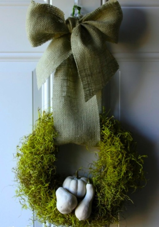an all-natural Thanksgiving wreath of moss, gourds and with a large green bow on top is a gorgeous idea to rock