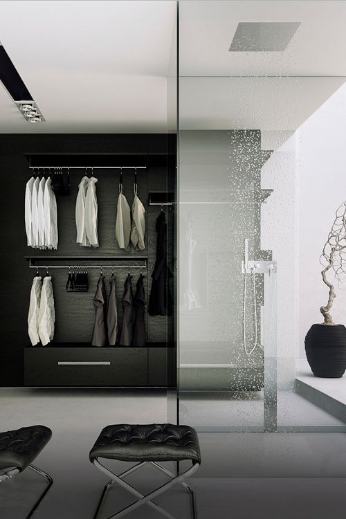 A minimalist black and white closet with a built in shower space enclosed in glass and a rain shower is a gorgeous idea to rock