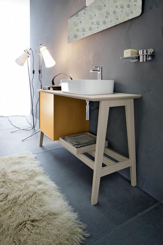 A stylish and functional mid century modern sink stand with a storage cabinet and an open shelf is a lovely idea for a modern bathroom