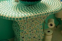 a creative and bold green mosaic sink stand is a pretty and catchy idea for a Moroccan bathroom or an eclectic one
