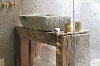 a rough wood sink stand and a rough concrete sink are great for styling the space in wabi-sabi, it’s a bold and cool solution