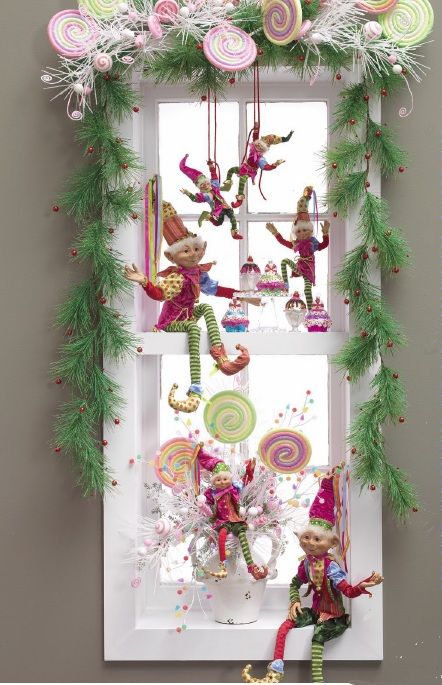whimsical Christmas window decor with faux fir, verries, elves and candies is a lovely and fun idea to rock