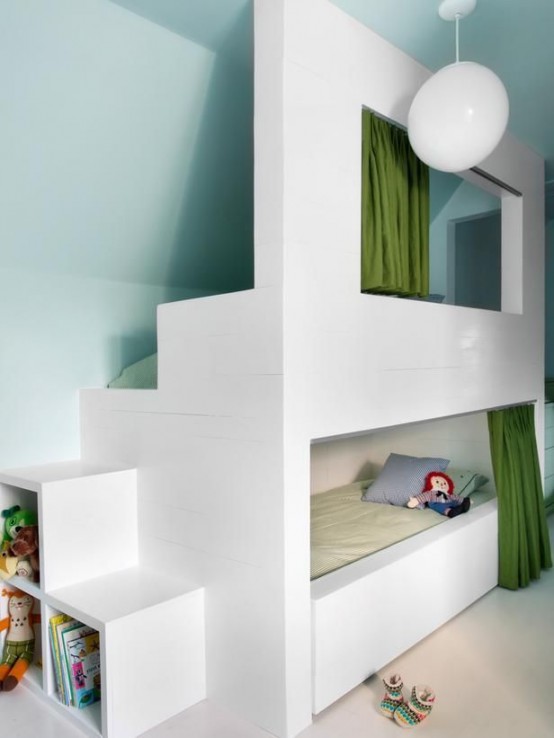 a small kids' room with aqua walls, with a built-in bunk bed and neutral bedding, with curtains for privacy and lots of toys and other stuff