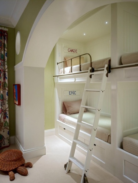 A neutral kids' room with four built in bunk beds, a ladder, neutral bedding is a great way to accommodate kids and save space
