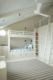 a white kids’ room with a bunk bed and an additional one on top, printed textiles is a great space for three children