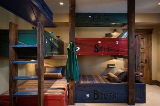 a rustic kids' room with super bright kids' bunk beds in navy and red, with a wooden ladder is a cool idea that saves space
