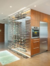 a large clear glass wine cooler as part of the kitchen – put your wine on display and enjoy