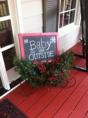 a vintage cart with a chalkboard sign, evergreens, pinecones, berries is a lovely vintage rustic decoration to rock outdoors