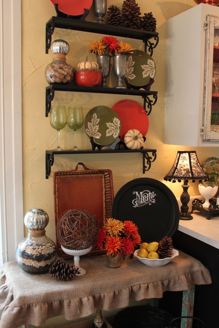 Oversized pinecones, fall colored and painted plates, bright blooms and citrus for fall kitchen decor
