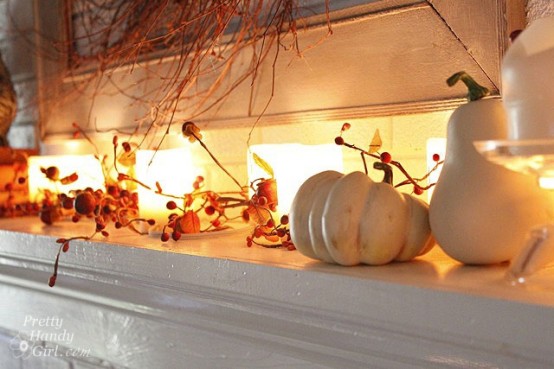 decorate the mantel with candles, white pumpkins and gourds and berries and leaves for an elegant feel