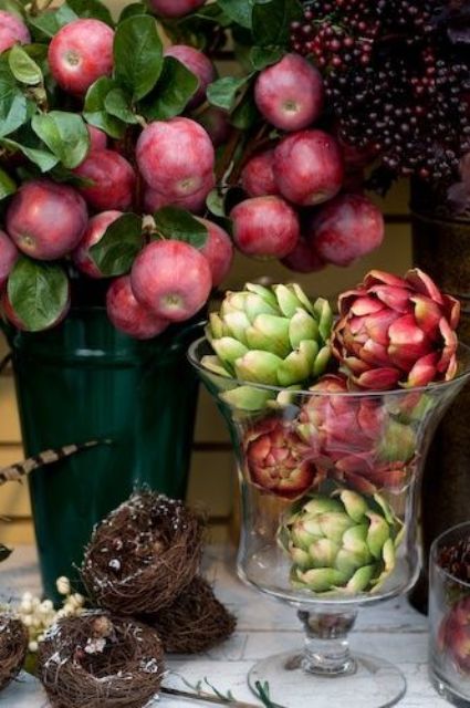 a alrge and tall glass vase with artichokes is a great idea for a fall centerpiece or just as a decoration