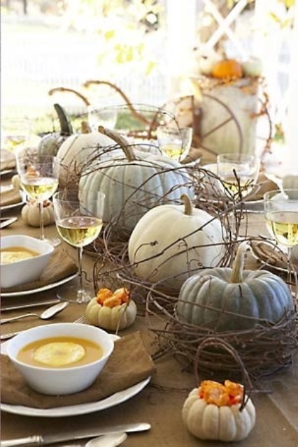 a natural fall tablescape with a brown tablecloth and napkins, neutral pumpkins and vine