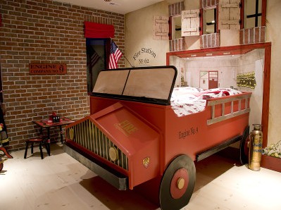 This awesome room feature a one-in-a-kind DIY firetruck bed with an awesome background.
