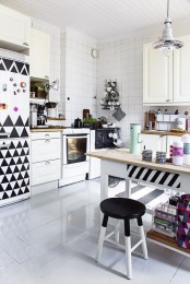 a cozy black and white kitchen with cool geometric elements