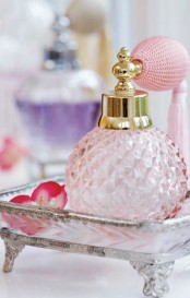 a vintage pink perfume bottle on a stand is a chic decoration for a closet or a makeup vanity, even if you don’t ever use it