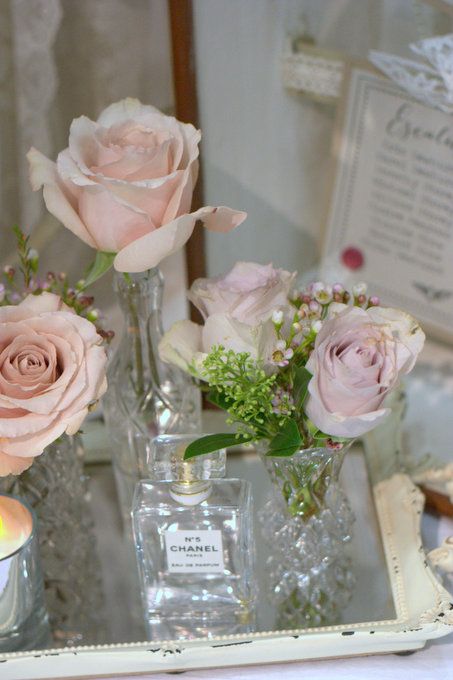 vintage bottles and jars with light pink roses are a great arrangement for spring or summer, they look elegant and chic