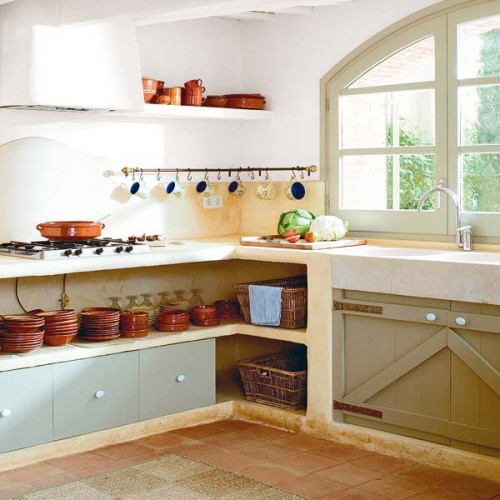 Built in kitchen furniture with open storage spaces for tableware and some drawers for storage is a great solution for a rustic space