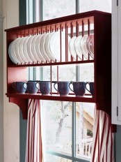 a creative rack with a plate stand and a shelf for cups is a cool idea for any kitchen