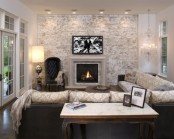 an elegant and refined living room with a whitewashed brick statement wall that adds a casual feel