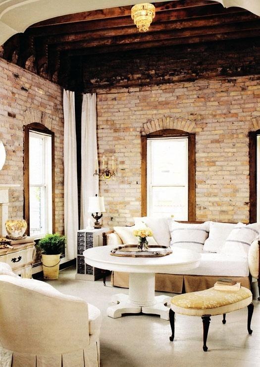 a refined vintage living room with elegant furniture and whitewashed brick walls and a wooden ceiling for a vintage feel