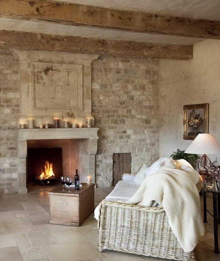A French farmhouse living room with a statement white brick wall and a built in fireplace