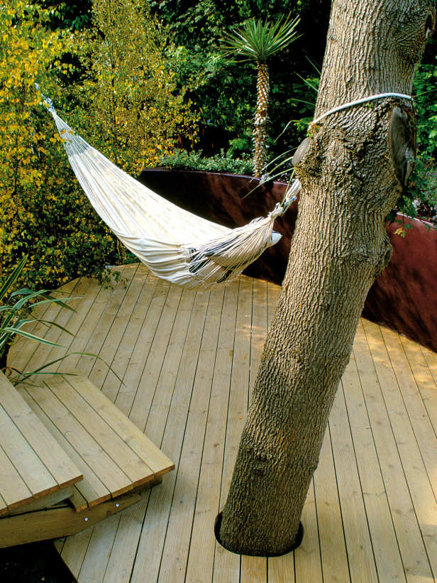 A small and simple deck with a hammock and steps   who needs more to relax