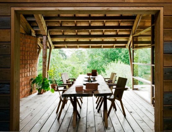 a rustic deck with a living edge table and wooden chairs and potted greenery for a fresh touch