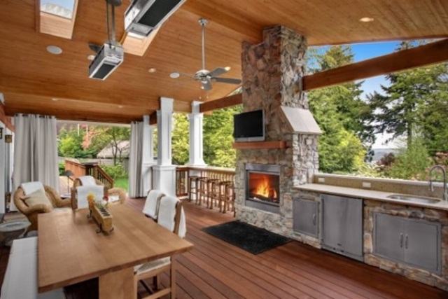 if your kitchen is located on a deck then combining it with lounge area with a fireplace is a super cozy way to go.