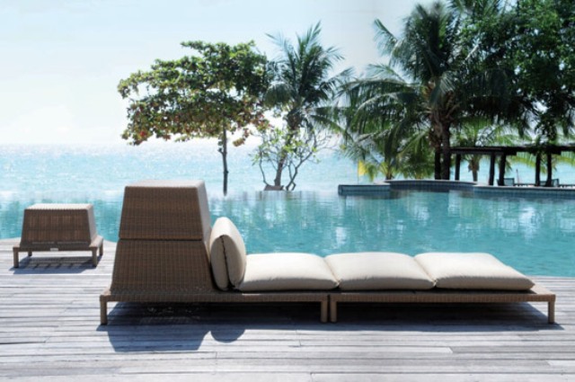 A large and long outdoor wicker lounger with some storage space is a cool idea to relax and to store towels in it