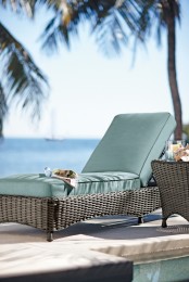 a classic dark wicker lounger with green upholstery is a nice idea for manu backyards and various outdoor spaces