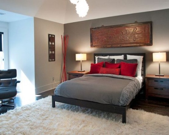 a modern grey, black and red bedroom with dove grey walls, black furniture, grey and red bedding is a bold and contrasting space