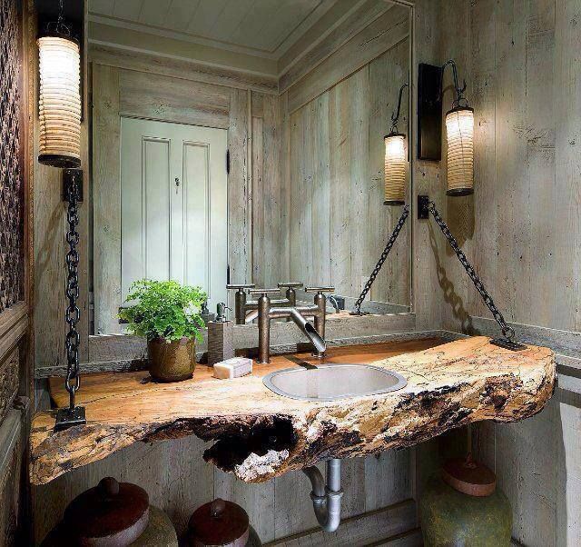 weathered wooden plank walls and a living edge vanity with a metal sink