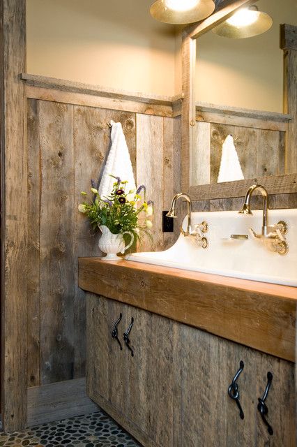 a rustic bathroom with much weathered wood and a large vanity