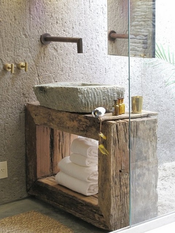 a wabi-sabi bathroom with a weathered wooden vanity and much stone all around