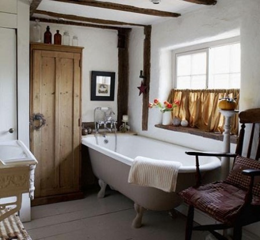a white cottage bathroom with light-colored wooden furniture and whitewashed wood 