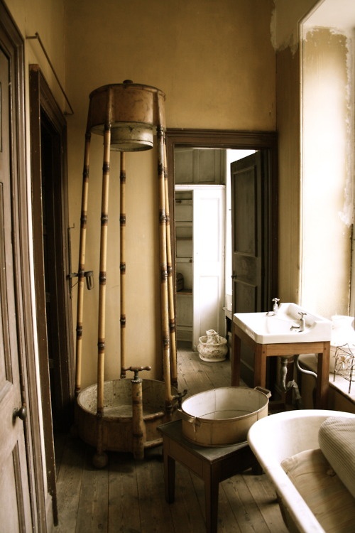 a vintage meets rustic bathroom with much wood and vintage items