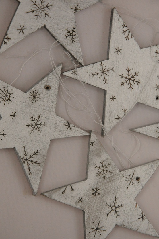 white wooden star ornaments with wood burnt snowflakes are amazing for cozy Christmas decor