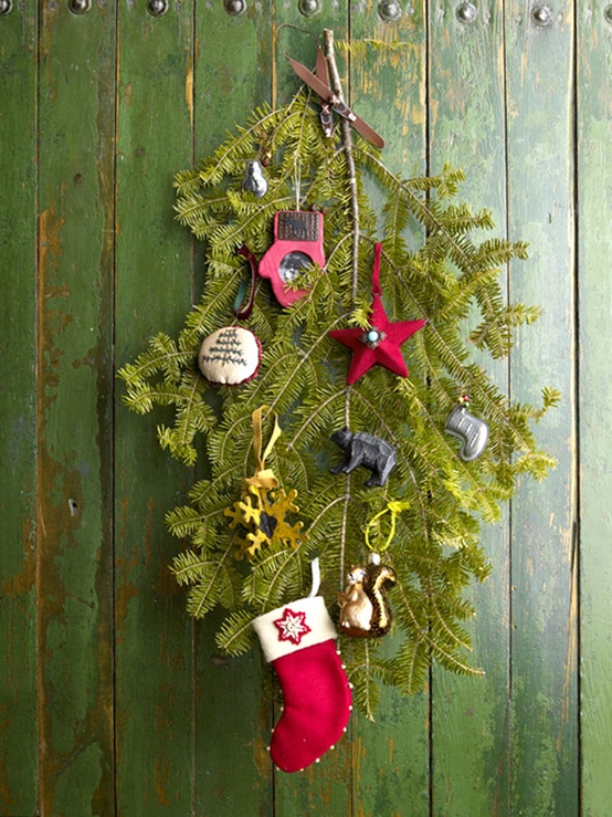a rustic decoration of evergreens and metallic and red whimsy Christmas ornaments plus a mini stocking