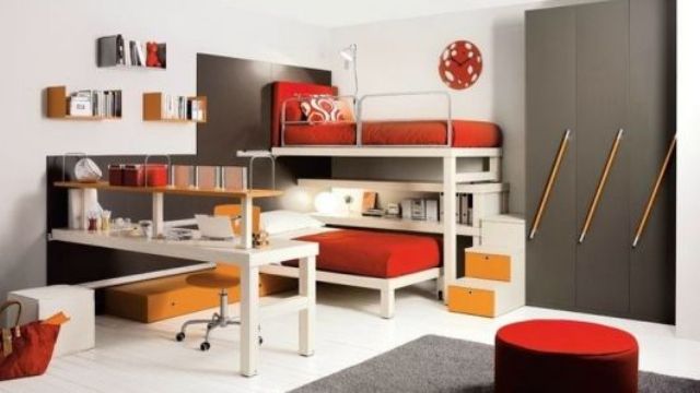 a stylish modern teen boy bedroom with white and grey walls, bunk beds, a desk, a grey wardrobe and touches of mustard and red