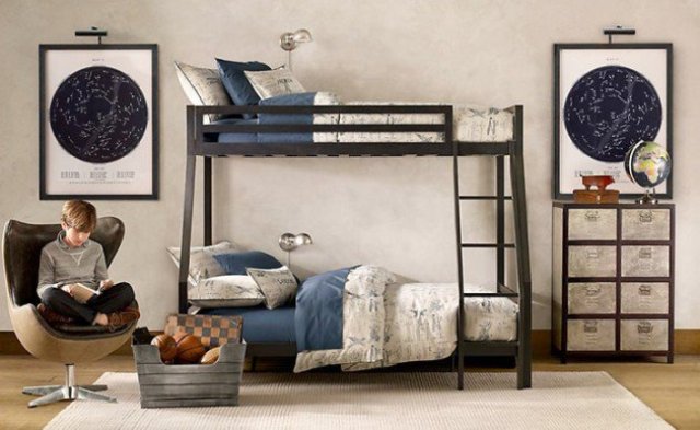 a stylish shared teen boy bedroom with a black bunk bed, a map covered cabinet, sky maps on the walls and comfy chairs