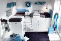 a modern shared teen boy bedroom with white walls and furniture, with beds placed on cabinets, bright blue accents
