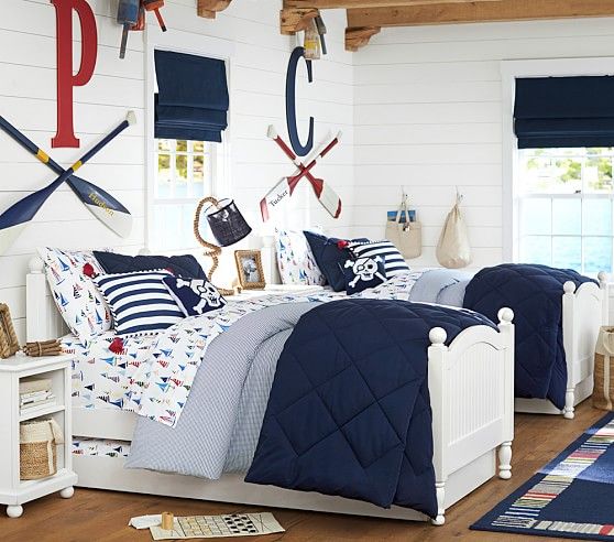 a nautical shared teen boy bedroom with white walls, oars and monograms plus nautical bedding