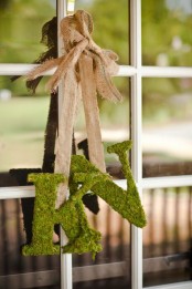 hang some moss monograms on burlap ribbons instead of usual wreaths on your front door