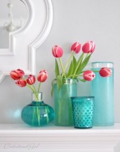 an arrangement of various turquoise-colored vases with bright blooms is a lovely idea to decorate your space and they will give a gentle touch of color to it