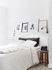 white ledges over the bed with pretty artworks are a great way to personalize your small bedroom without using any table or floor space