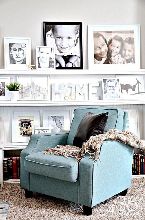 a chic reading nook with bookshelves and long white ledges with artworks, photos, potted greenery and monograms