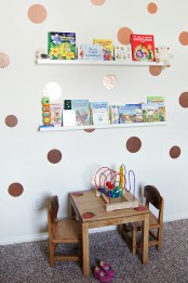 a playroom with ledges over the table with kids’ books – this is a simple and cool idea to store books without using floor or table space
