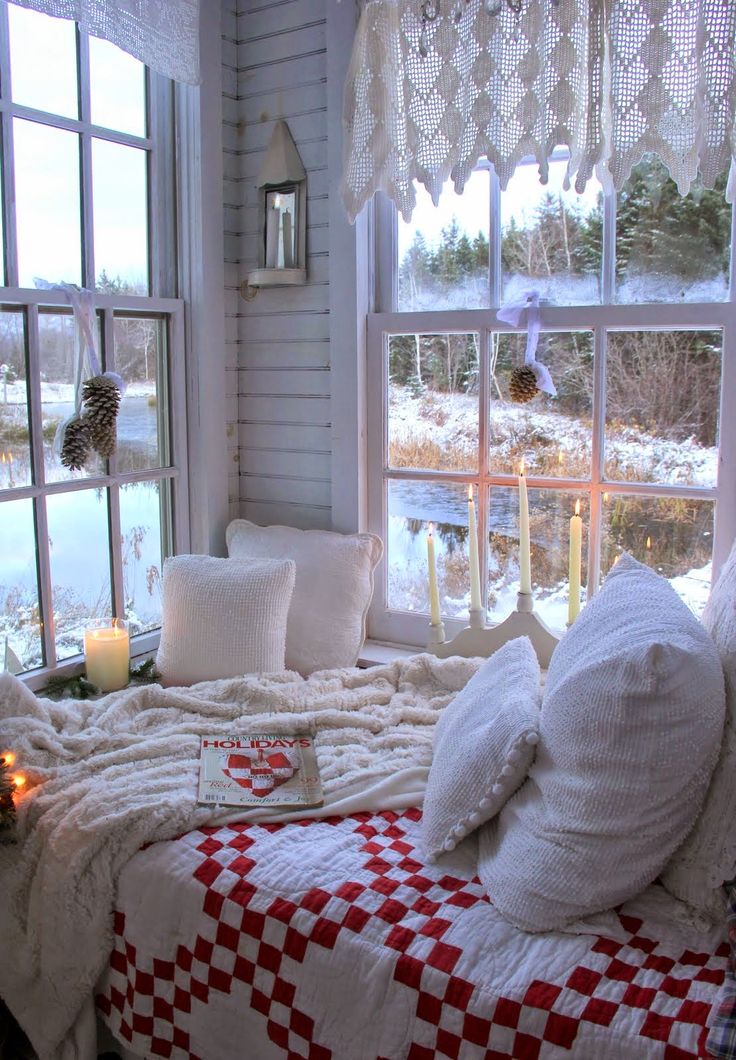 White crochet curtains, pinecone posies, knit bedding and plaid textiles plus candles for a winter like space